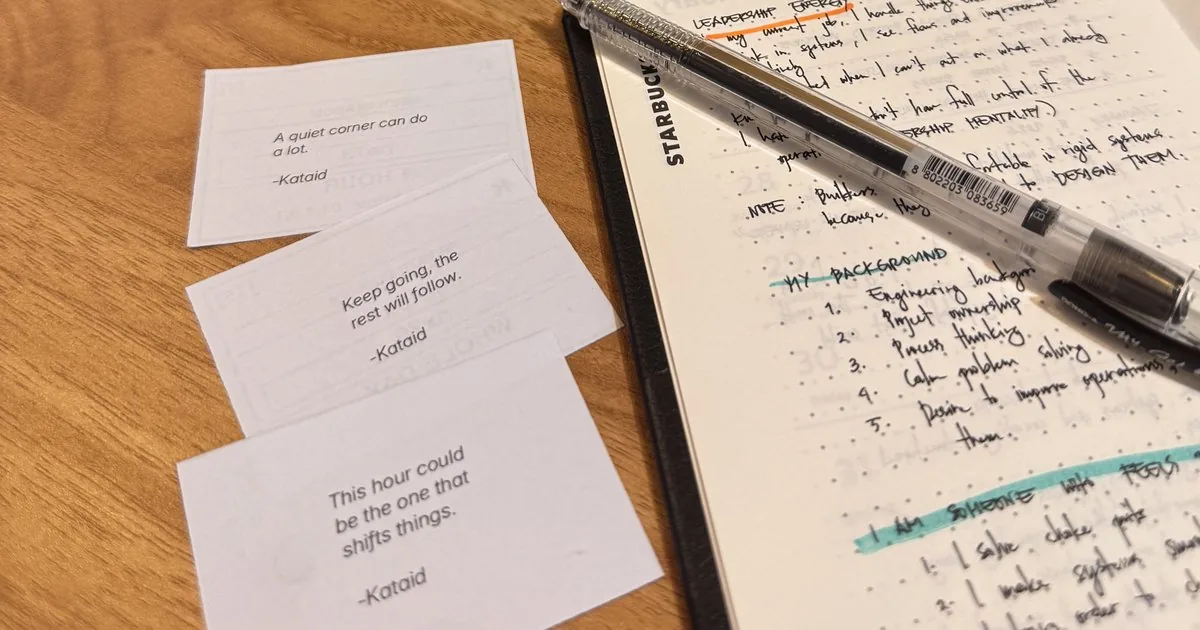 Three Kataid WiFi cards on a desk beside an open notebook.
